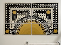 a bathroom with a black and yellow tiled wall